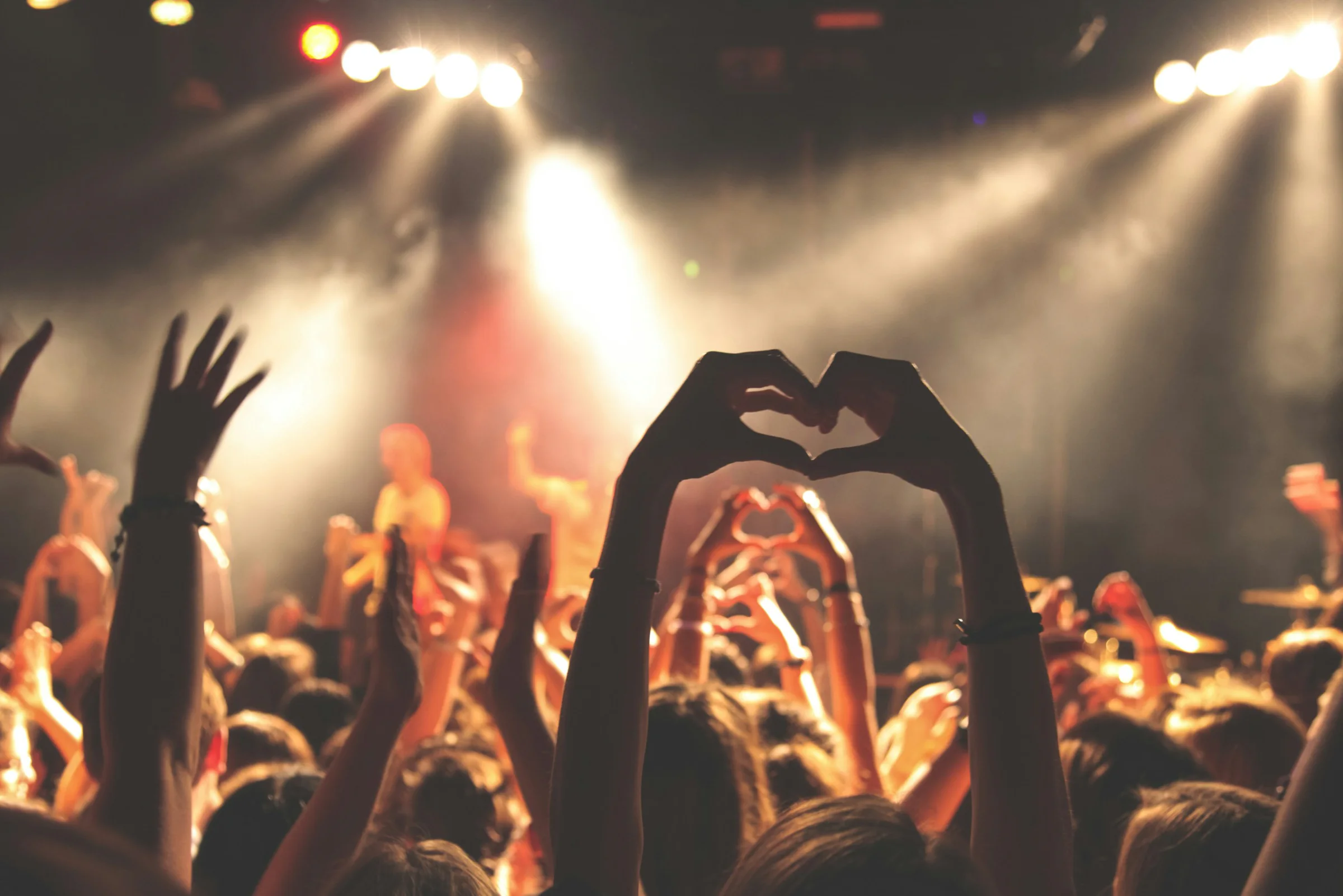 Crowd with hands raised at a live music festival